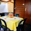 Terrazza con tavolo giallo e sedie nere.